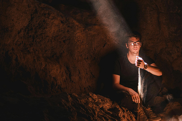 A man in a cave needing PTSD therapy
