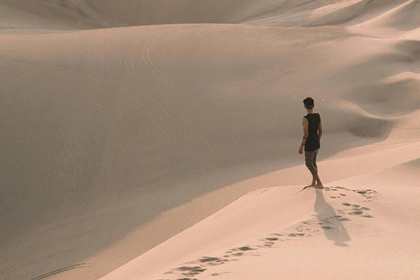 a man needing drug abuse treatment walking in the desert